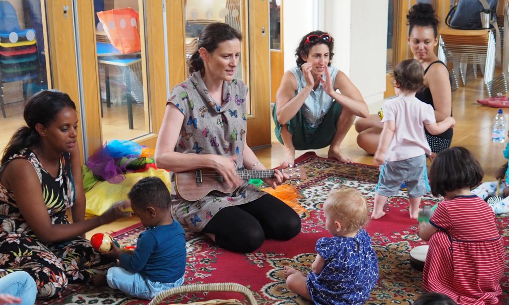 Women and children playing at a nursery